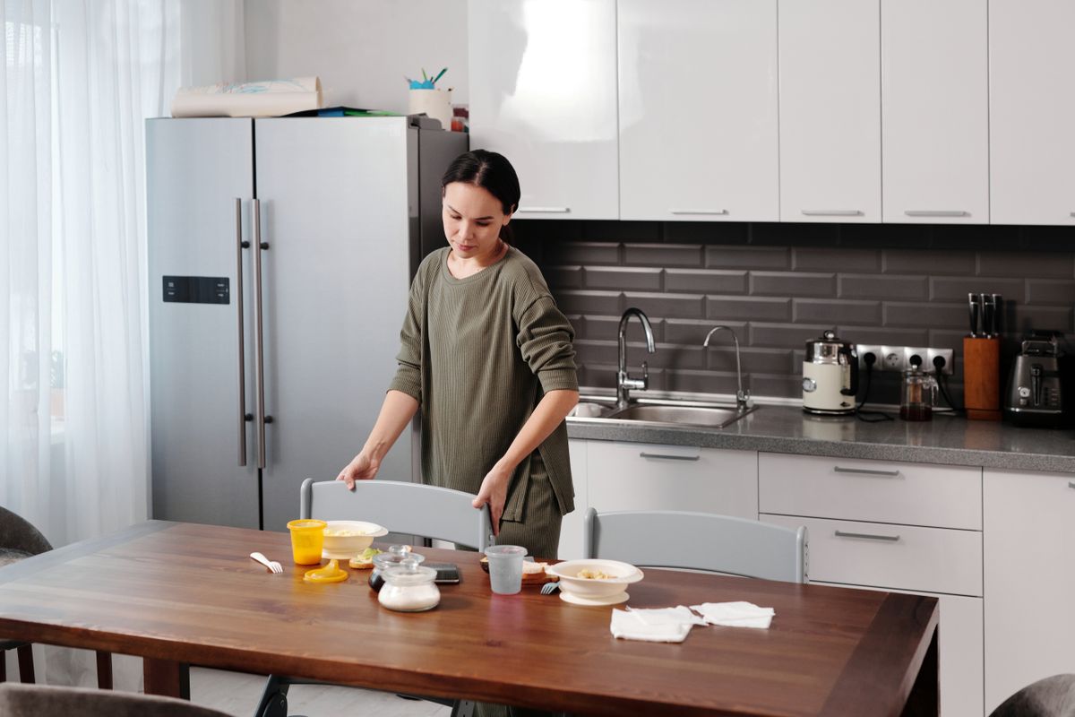 Professional cleaner preparing a kitchen for an end of lease inspection